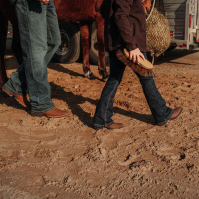 Father and daughter grooming horse wearing Durango Shyloh western boots