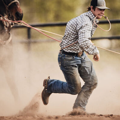 Tie-down roper wearing DDB0414 western rodeo performance boot