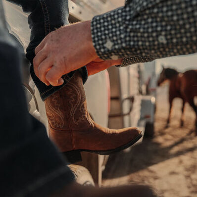  Father and son grooming horse wearing Durango Shyloh western boots
