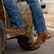 Man climbing on tractor wearing Maverick XP™ Durango work boots 
