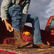 Cowboy on truck bed pulling on DDB0379 Westward western boot