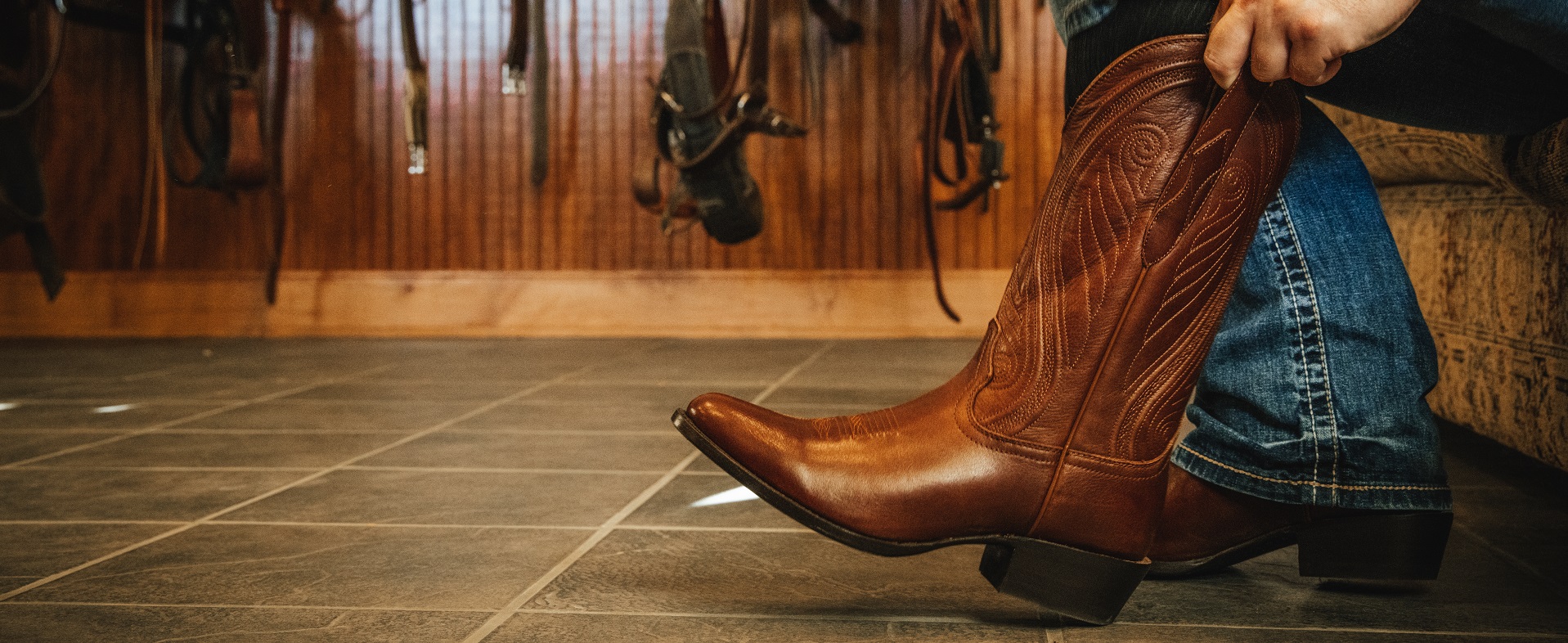 Man pulling on a pair of Santa Fe Western Boots