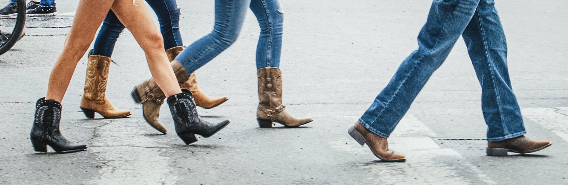 Man pulling on a pair of Santa Fe Western Boots