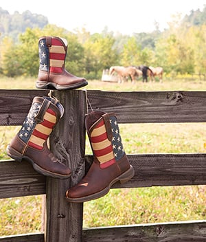 Rebel by Durango Flag Boots on a fence