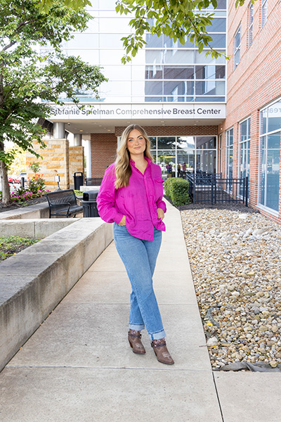 Maddie Spielman, daughter of Stefanie and Chris Speilman, in front of
                            the Stefanie Spielman Comprehensive Breast Center in Columbus, Ohio